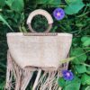 braided leather bag with wooden handles and fringes