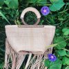 braided leather bag with wooden handles and fringes